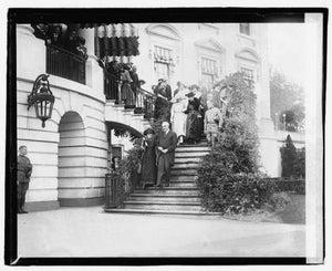 Marie Curie and President Warren Harding walk down the White...